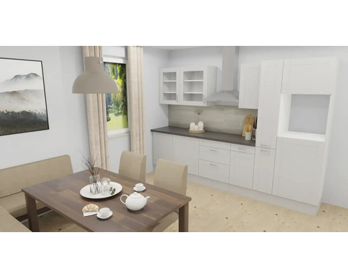 Cuisine lumineuse et organisée avec meubles blancs, plan de travail sombre et table à manger en bois avec service à thé et chaises beiges.