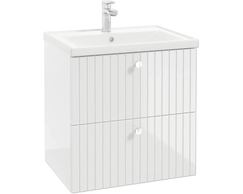 Meuble sous-lavabo blanc avec façades de tiroirs rainurées, lavabo et robinet.