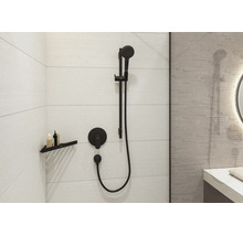 Salle de bain organisée avec set de douche noir, douchette et mitigeur encastré sur carrelage, étagère d'angle moderne et ambiance lumineuse.