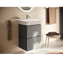 Moderner wandhängender Waschtischunterschrank mit Keramikwaschbecken, zwei Schubladen und beleuchtetem Spiegel in einem hellen Badezimmer.
