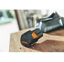 Batterie lithium-ion Stihl AS 2 pour le système AS sur une surface en bois.