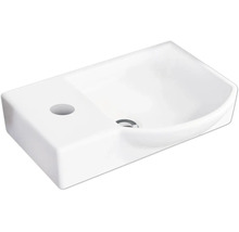 Lavabo en céramique avec trou de robinetterie latéral et vasque intérieure arrondie.
