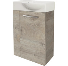 Meuble sous-vasque aspect chêne avec lavabo en céramique blanc et une poignée en métal.