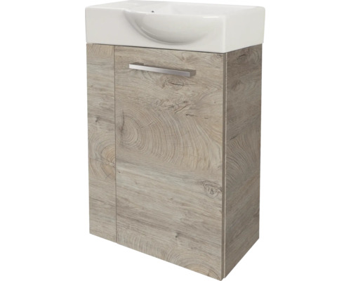 Meuble sous-vasque aspect chêne avec lavabo en céramique blanc et une poignée en métal.