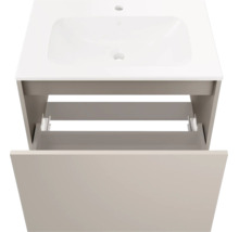 Meuble sous-vasque composé d'un lavabo blanc et d'un meuble bas beige avec un tiroir ouvert.