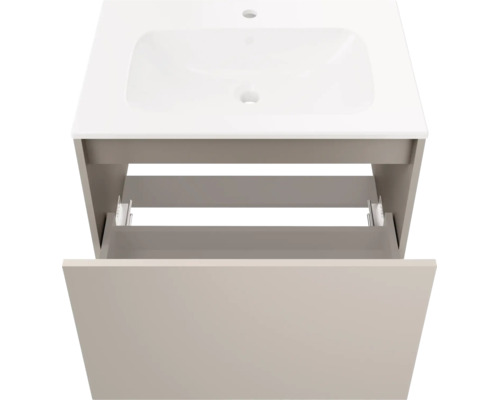 Meuble sous-vasque composé d'un lavabo blanc et d'un meuble bas beige avec un tiroir ouvert.