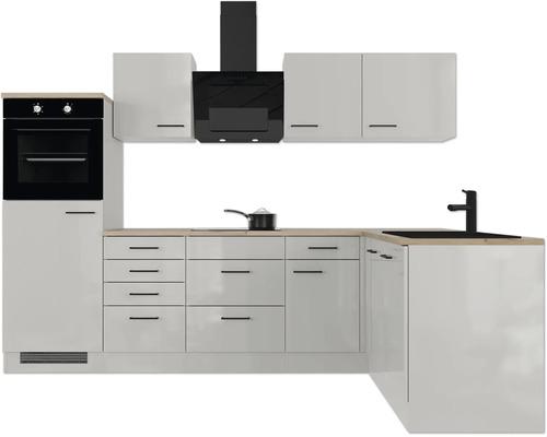 Cuisine moderne en L avec façades blanches, appareils électroménagers noirs, évier et plan de travail aspect bois.