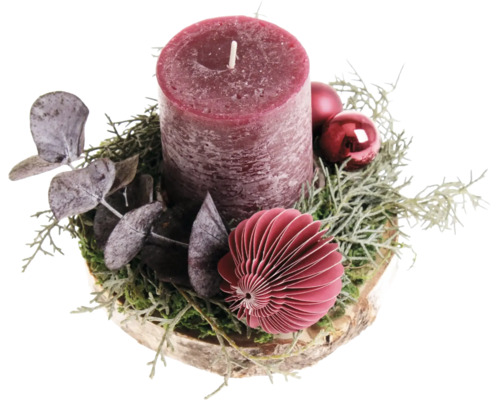 Centre de table de Noël avec bougie pilier sur un disque en bois décoré d'eucalyptus et de boules de Noël