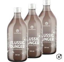 Drei Flaschen Wundergarten Flüssigdünger mit 15 Prozent Pflanzenkohle, Inhalt je 330 Milliliter. (Image AI modified or generated)