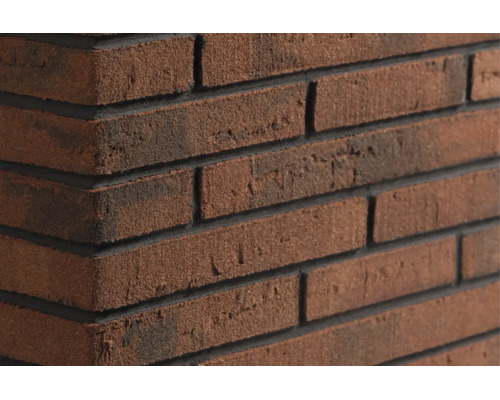 Gros plan d'un mur en briques texturées avec des joints sombres