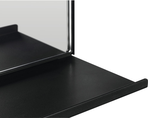 Detailaufnahme eines schwarzen Wandspiegels mit Ablage