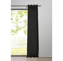 Vue d''une pièce avec un rideau à œillets noir devant une fenêtre