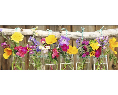 Dekorative Blumen in Glasvasen, aufgehängt an einem Ast