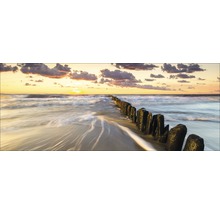 Coucher de soleil sur la plage avec des poteaux en bois dans l''eau