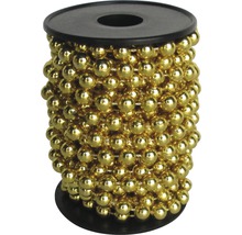 Goldfarbene Perlenkette auf einer schwarzen Spule