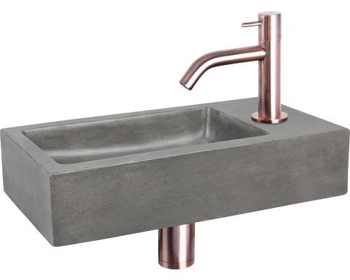 Lavabo en béton gris avec robinetterie