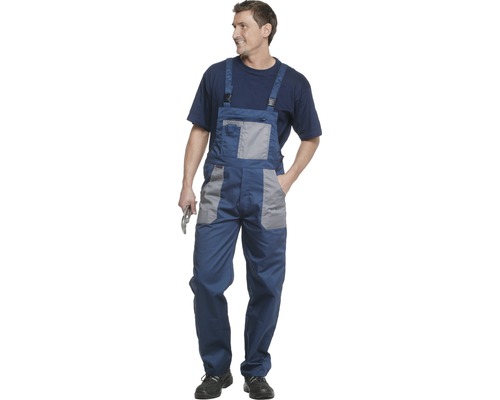 Homme en salopette bleue avec un outil à la main