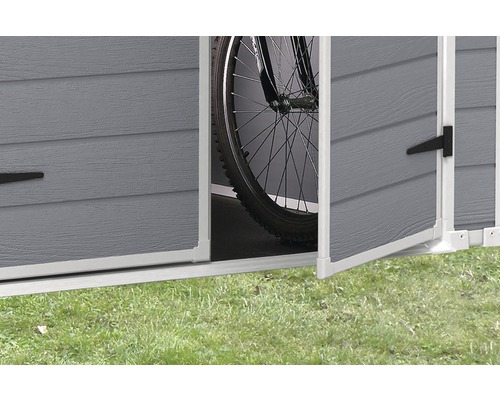 Detailansicht eines Gerätehauses mit geöffneten Türen und einem Fahrrad im Inneren