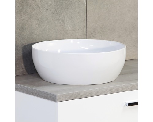 Vasque à poser en céramique sur un meuble sous-lavabo