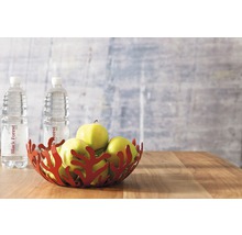 Coupe décorative avec des pommes et des bouteilles d''eau sur une table en bois