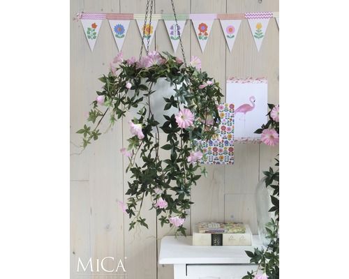 Dekorative Hängepflanze mit rosa Blüten in weißem Topf vor Holzwand