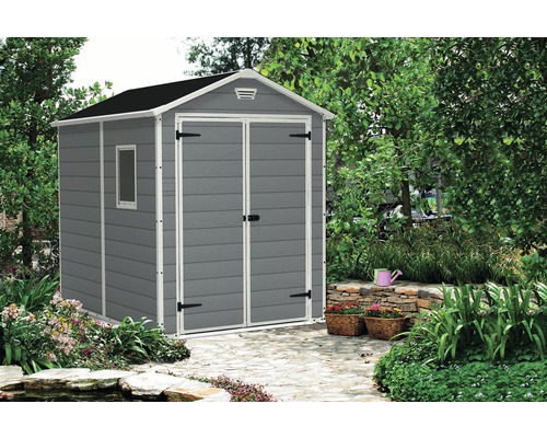 Abri de jardin gris avec fenêtre dans le jardin