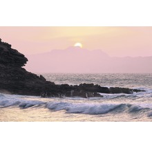 Sonnenuntergang über einer Küstenlandschaft mit Felsen und Wellen