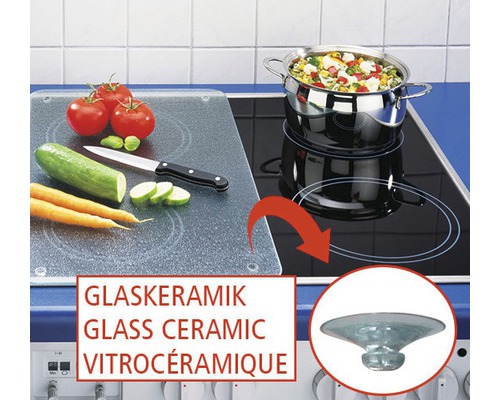 Plaque de cuisson vitrocéramique avec légumes, casserole et saladier en verre