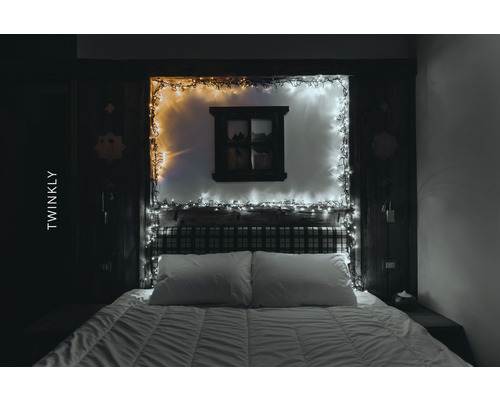 Schlafzimmer mit Bett und dekorativer Lichterkette
