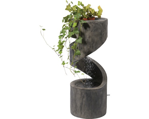 Dekorativer Zimmerbrunnen in Spiralform mit Bepflanzung