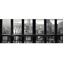 Photo en noir et blanc d''une vue de la ville à travers une fenêtre