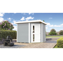 Abri de jardin gris avec porte blanche et toit blanc sur une terrasse.