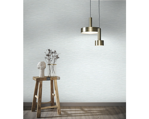 Wohnraum mit Tapete in Wellenoptik, Pendelleuchten, Hocker und Dekoration