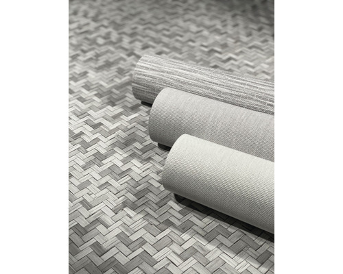 Drei Rollen Textiltapete auf einem geflochtenen Untergrund