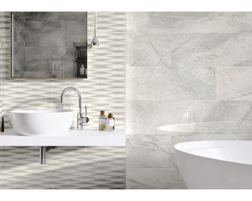 Salle de bain avec lavabo, baignoire et carreaux muraux aspect marbre
