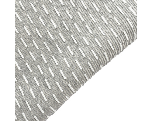 Gros plan d''un tapis gris avec motif blanc