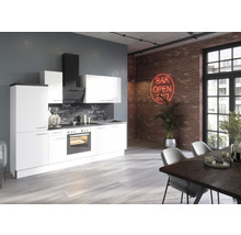 Moderne Küche mit weißen Fronten, Dunstabzugshaube und Esstisch in einem loftartigen Raum mit Backsteinmauer.