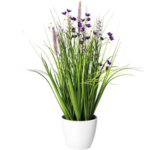 Dekorative Kunstpflanze mit grünen Gräsern und lila Blüten in einem weißen Topf