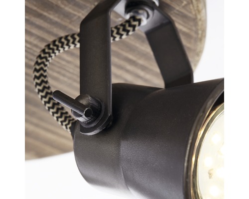 Gros plan d''un plafonnier noir avec câble textile