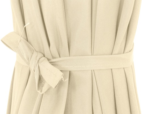 Gros plan détaillé d''un rideau en tissu beige avec un tissu plissé et un ruban en tissu