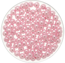 Perles décoratives roses dans une boîte transparente