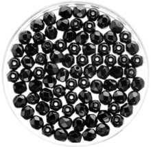 Schwarze Glasperlen in einem Behälter