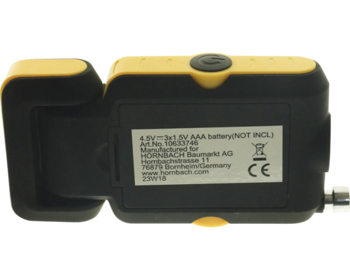 Arrière d''un instrument de mesure jaune et noir, indication sur le fonctionnement sur piles et marquage CE