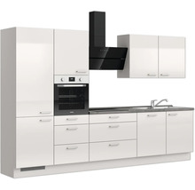 Cuisine moderne avec armoires blanches, four noir et hotte aspirante