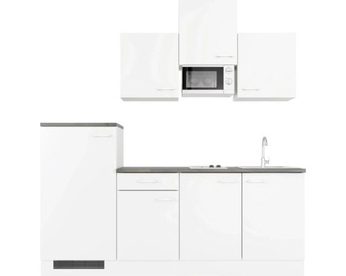 Weisse Küchenzeile mit Spüle, Herd und Mikrowelle