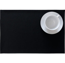 Schwarzes Tischset mit weißer Tasse und Untertasse