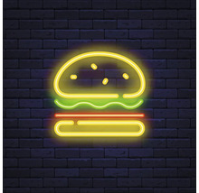 Enseigne au néon d''un hamburger devant un mur de briques
