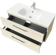 Meuble sous-vasque avec deux tiroirs ouverts et lavabo en céramique