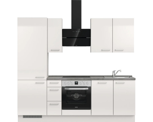 Cuisine moderne avec armoires blanches, hotte aspirante et cuisinière électrique