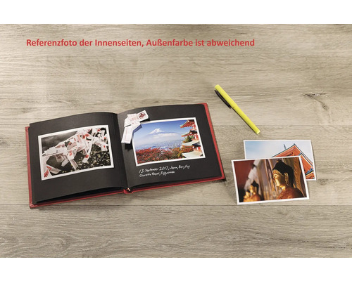 Album photo ouvert avec des photos et un stylo